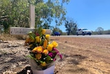 Flowers placed on the side of a rural highway