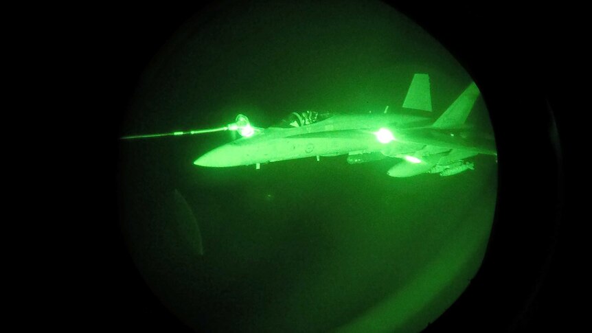Night Vision image of an FA-18A Hornet from Australia's Air Task Group refuelling from a Royal Australian Air Force KC-30A Multi Role Tanker Transport aircraft during the first mission of Operation OKRA to be flown over Syria