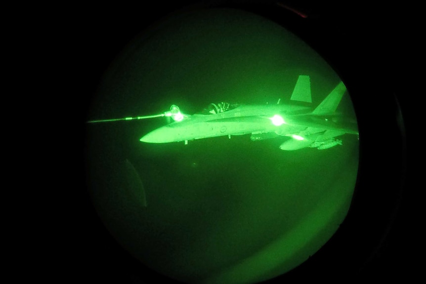 Night Vision image of an FA-18A Hornet from Australia's Air Task Group refuelling from a Royal Australian Air Force KC-30A Multi Role Tanker Transport aircraft during the first mission of Operation OKRA to be flown over Syria