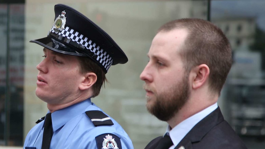 First Class constable Tom Gryta and an unknown man standing outside court