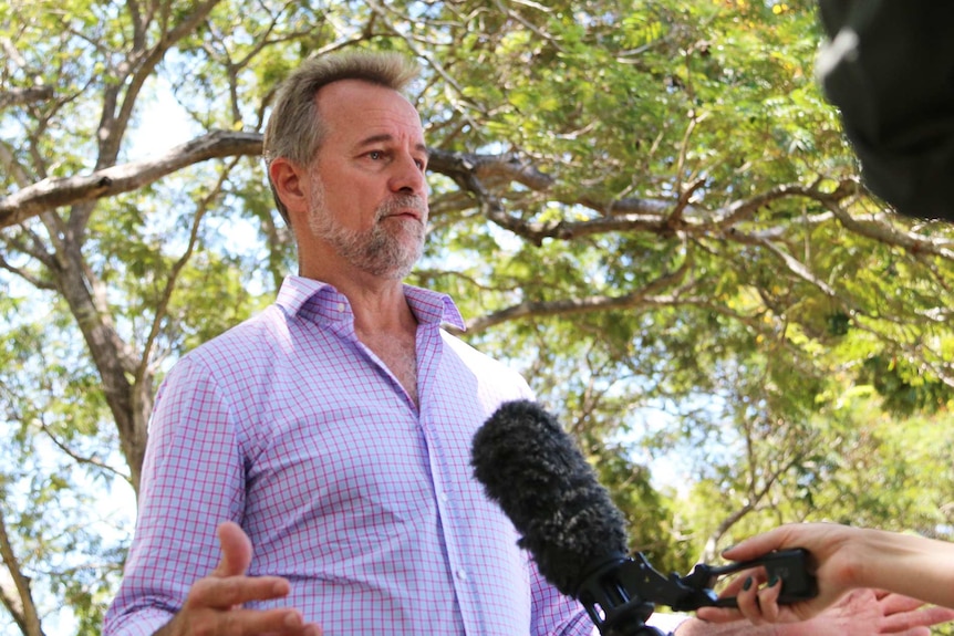 Senator Nigel Scullion speaks to Darwin ABC News in a park.