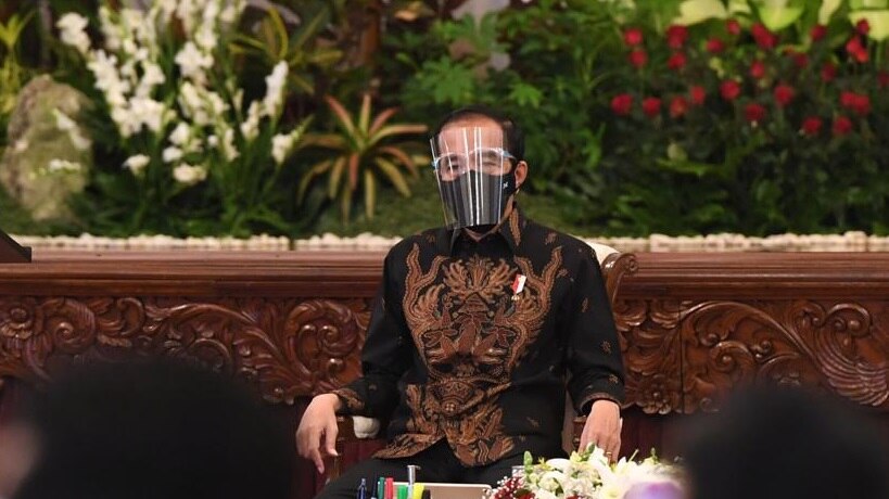 Indonesia's President Joko Widodo wears a face shield and black face mask during a meeting in Jakarta.