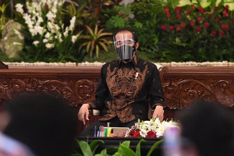 Indonesia's President Joko Widodo wears a face shield and black face mask during a meeting in Jakarta.