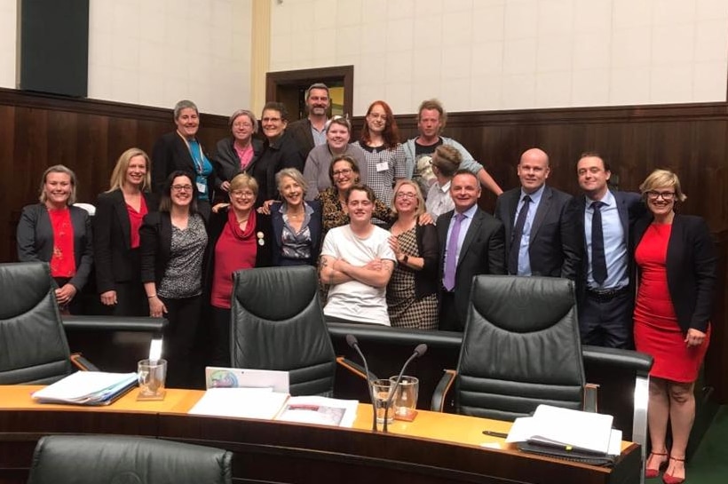 Labor and Greens MPs with gender reform supporters in Parliament after key votes.