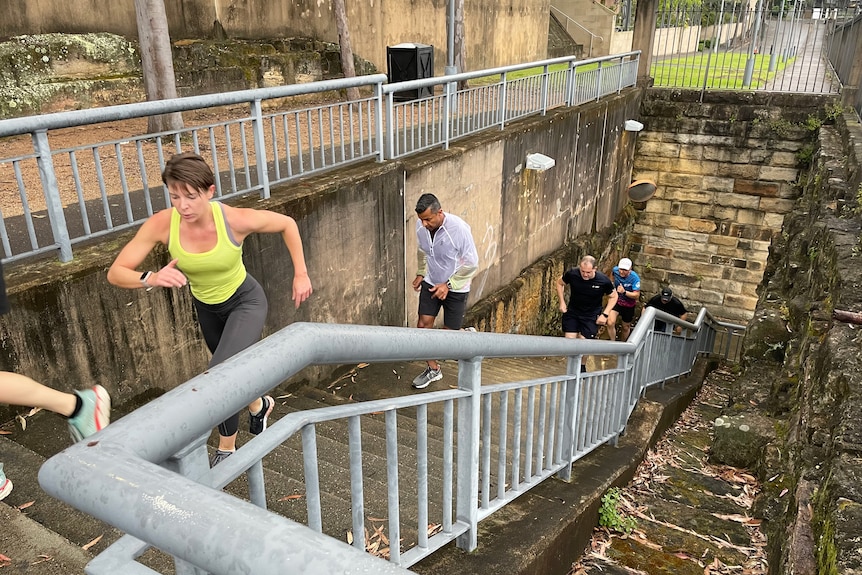 People run up an outdoor staircase