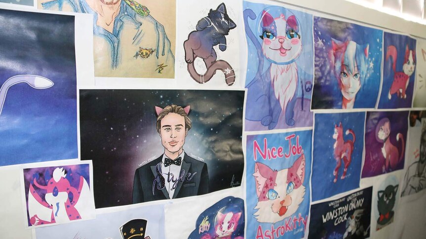 Fan art for Alex Hockings' AstroKitty YouTube channel posted on the wall in his office.