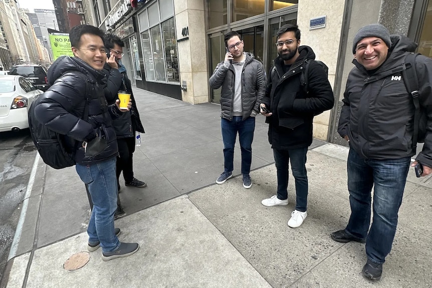 A bunch of men outside a bank