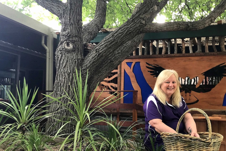 Reesha Stefek sits under a shady tree at the childcare centre