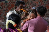 Devotees of Hindu God Muruga get the head of their child shaved.