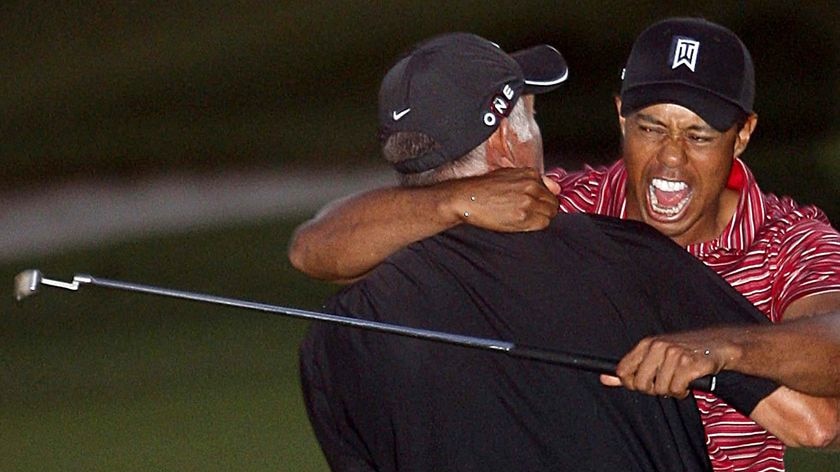 Tiger Woods hugs his caddie Steve Williams after winning the Arnold Palmer Invitational