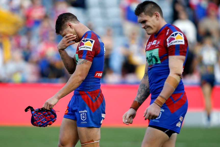 Two Newcastle Knights NRL players show their dejection after losing to Parramatta.
