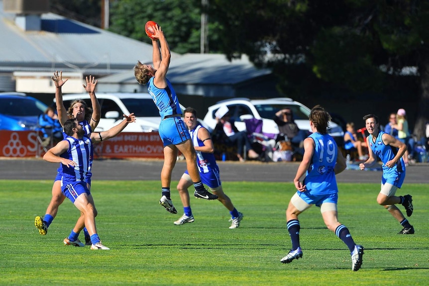 Riverland football player takes a mark.