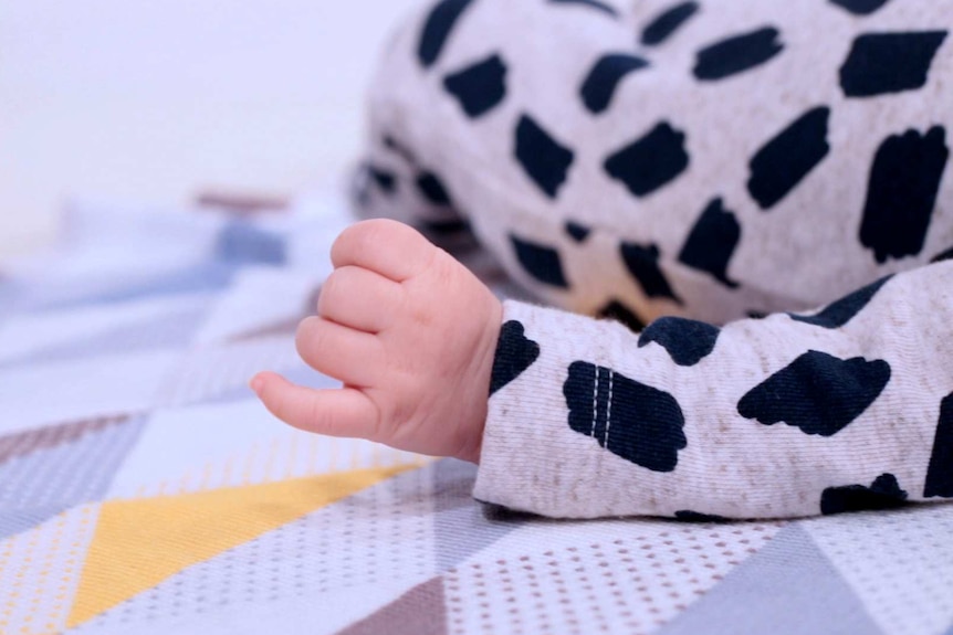 A close-up photo of an anonymous baby's hand.