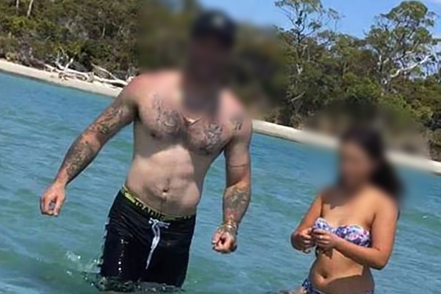 A shirtless man and woman in a bikini with faces blurred