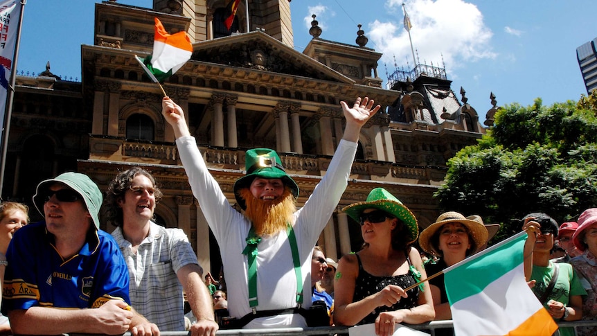 People celebrate in green in front of Town Hall in Sydney.