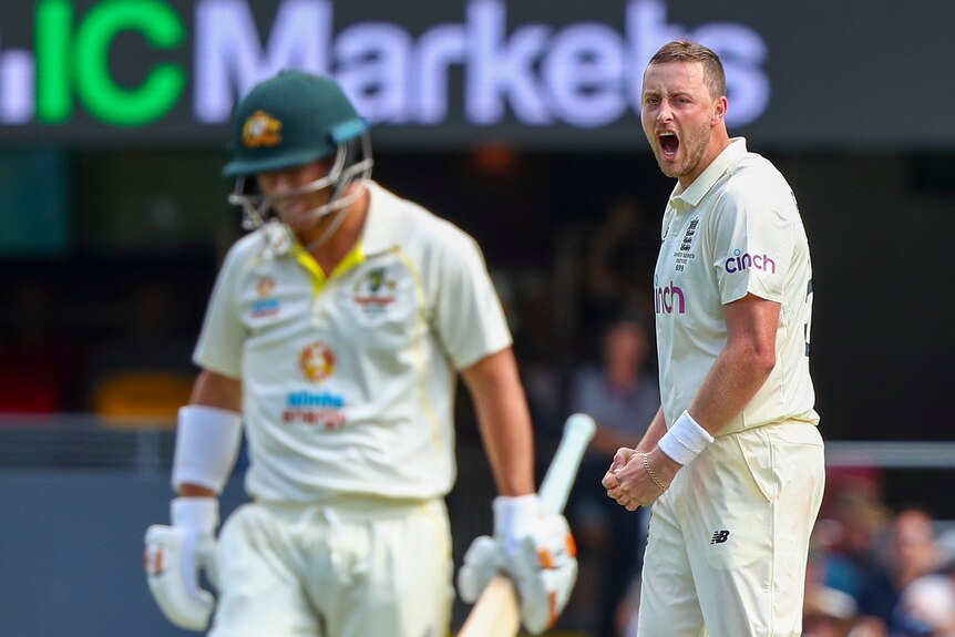 England bowler Ollie Robinson roars behind Australia batter David Warner after a dismissal on day two of the Ashes.