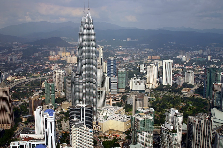 Skyline of Kuala Lumpur, Malaysia, showing a tall buildings densely packed together.