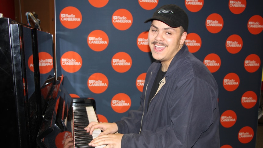 ACT musician Koebi Faumui playing piano and singing in ABC Canberra studio.