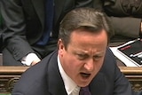 Britain's prime minister David Cameron is flanked by George Osborne and George Young during a parliamentary debate.