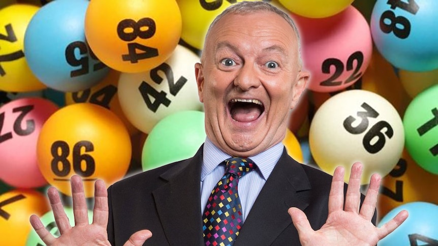 Antony Green in front of lottery balls