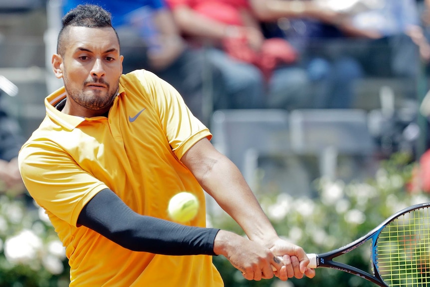 Nick Kyrgios of Australia returns the ball.