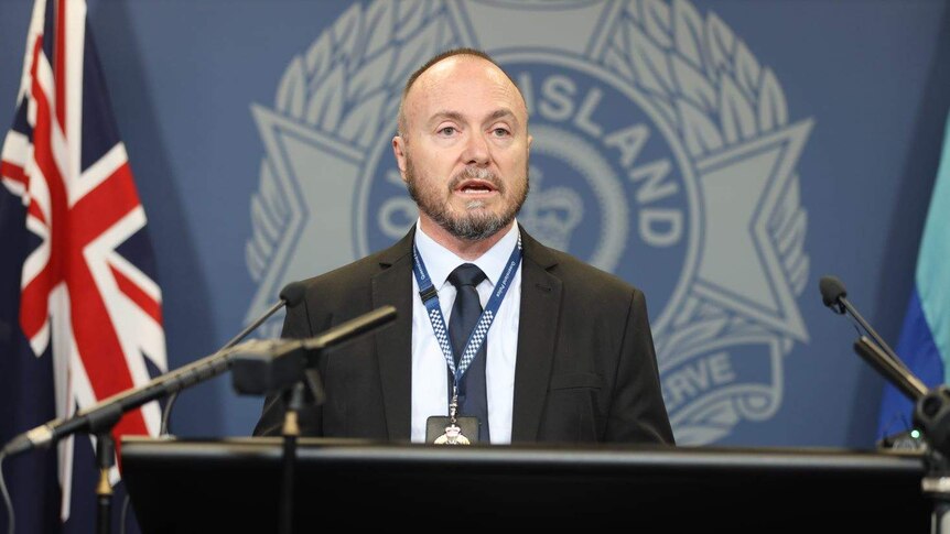 Detective Inspector Vince Byrnes addresses the media from a podium at police headquarters.