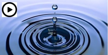 Droplets make ripples in water. Play button in corner.