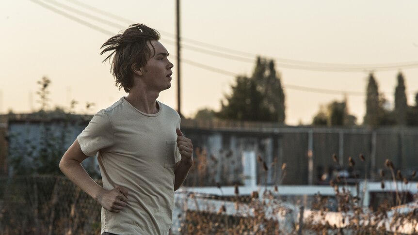 Colour still of Charlie Plummer running at dusk in 2018 film Lean on Pete.