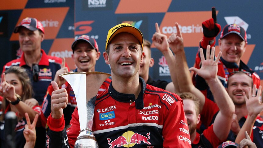 Red Bull Holden Racing Team driver Jamie Whincup with the Supercars Championship trophy.