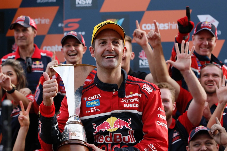Jamie Whincup with the V8 Supercars trophy
