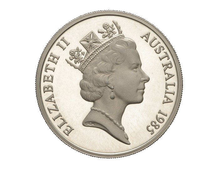 An Australian silver coin from 1985 bearing an effigy of Queen Elizabeth II wearing a crown. She appears to be middle-aged. 