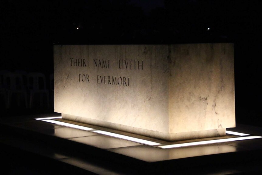 A lit stone reading "their name liveth for evermore".