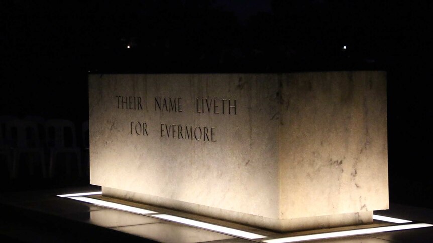 A lit stone reading "their name liveth for evermore".