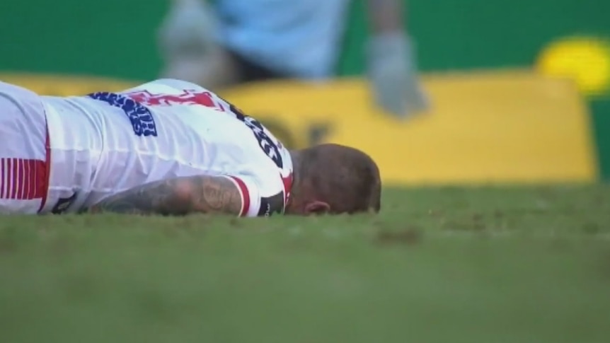 Josh Dugan lies on the ground after being knocked out