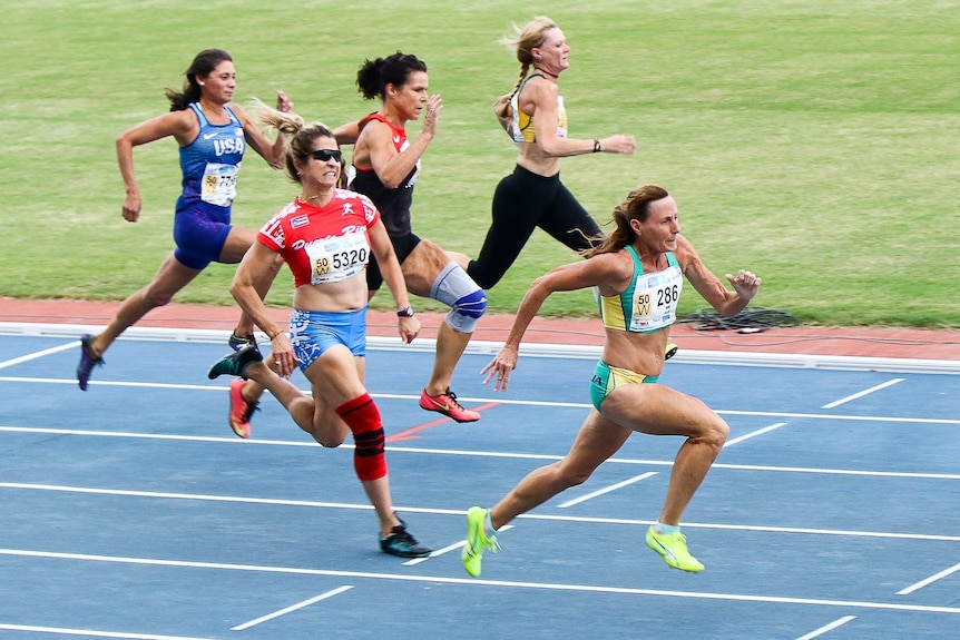 Five women sprint on track, Australian Julie Brims is in the lead.