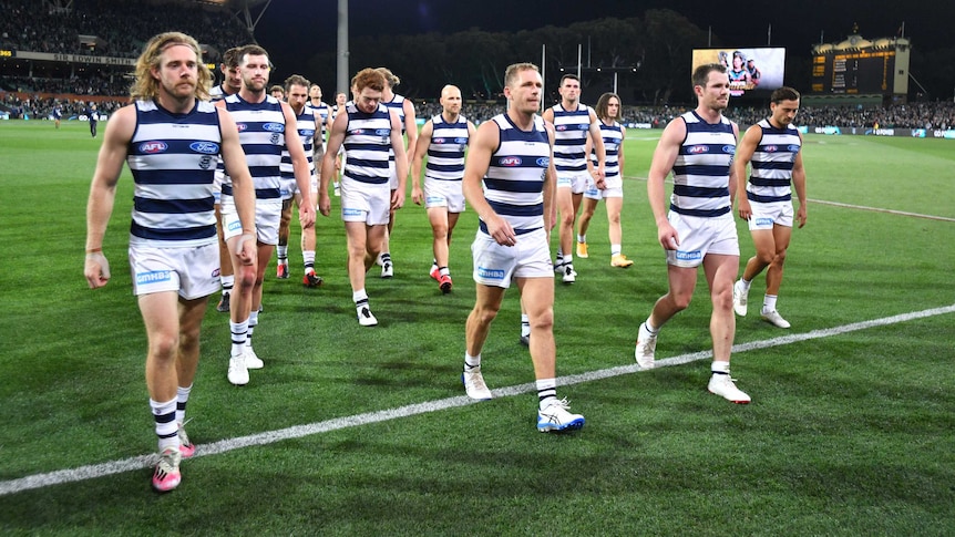 A dejected group of AFL players come from the ground after losing their first final.