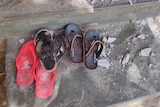 Sandals are seen at a local school that was damaged by an air attack.