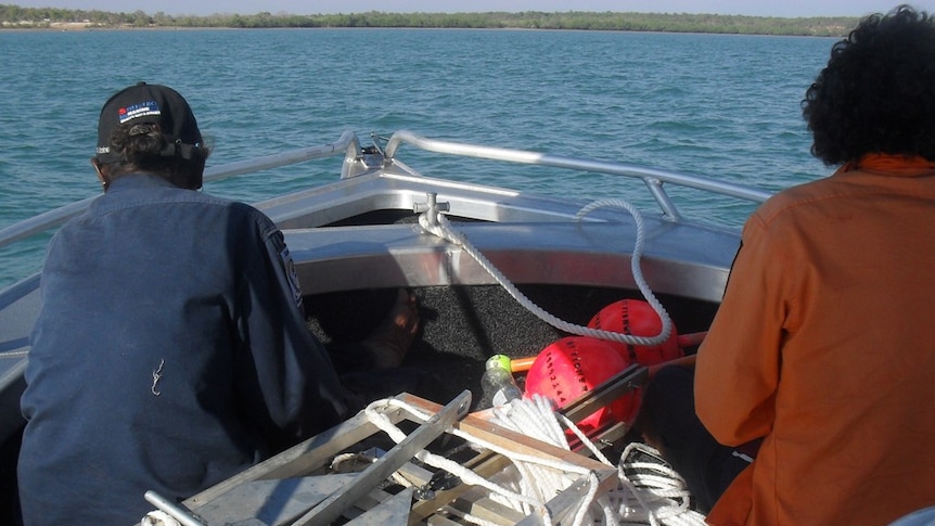 Kenbi rangers aboard their new boat, MV Kenbi,  prepare to place fish monitoring cameras in Belyuen harbour