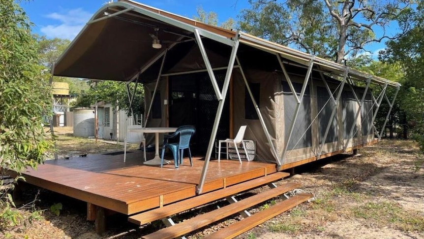 An african style glamping tent with a small deck in front of it