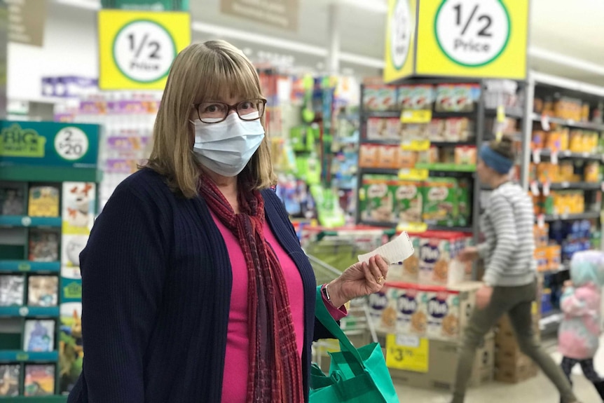 A woman wearing surgical face mask in Woolworths shopping centre