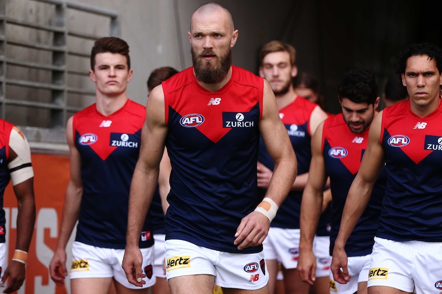 Max Gawn has a steely look on his face as he walks onto the field ahead of his teammates.