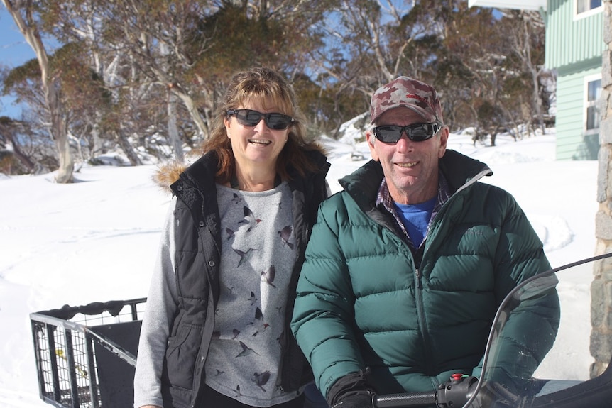 A man and woman at the snow.