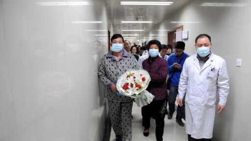 An H7N9 bird flu patient walks in the corridor of a hospital after his recovery