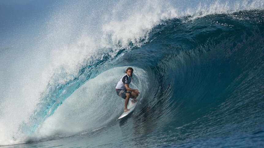 Matt Wilkinson rides a wave on Teahupoo reef in Tahiti