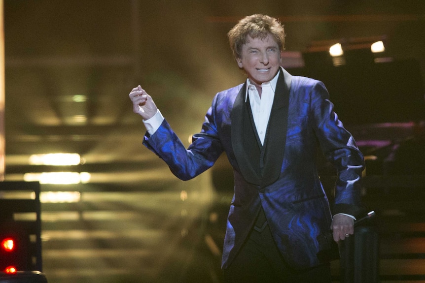 Barry Manilow performs on stage