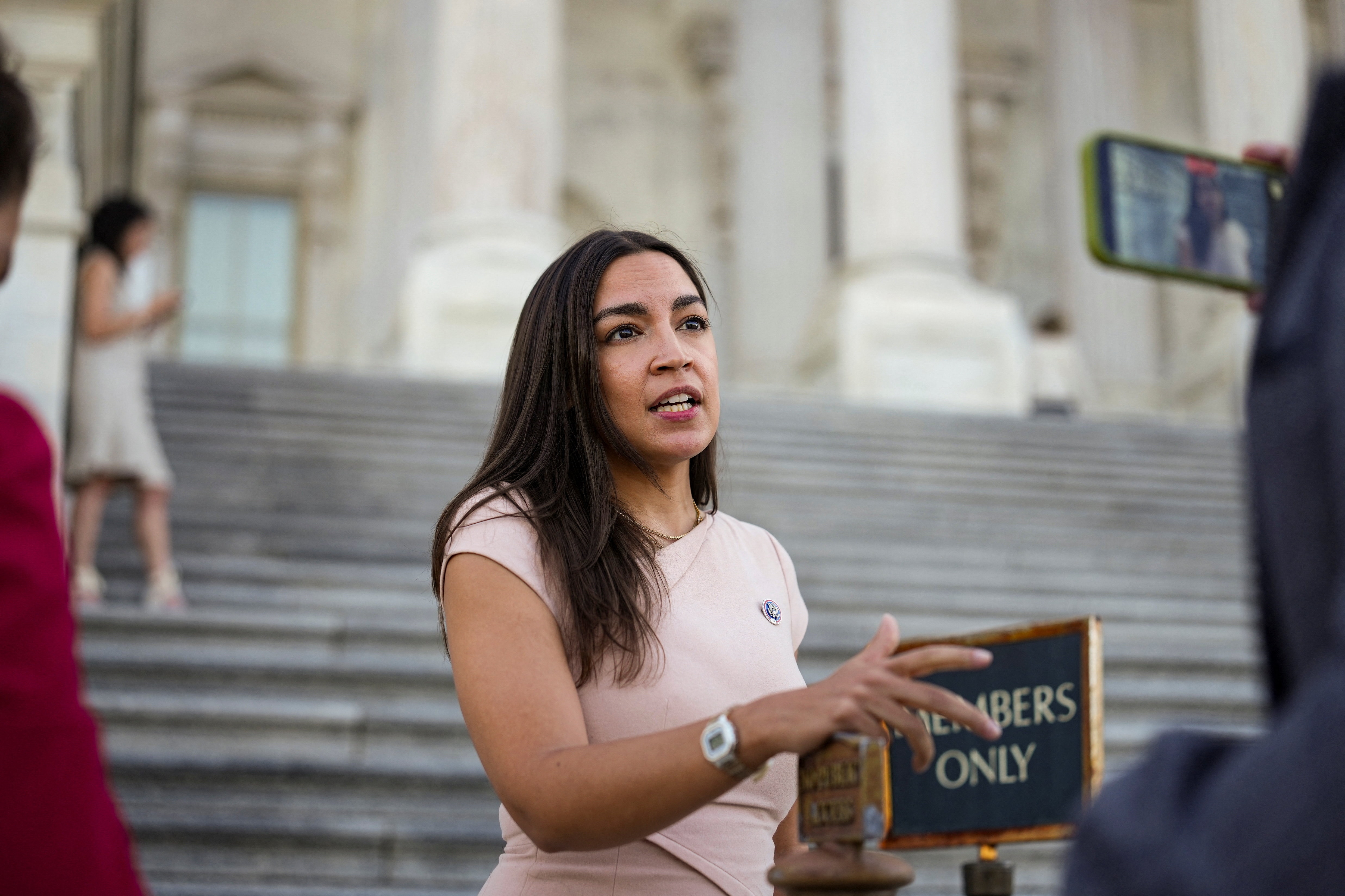 Alexandria Ocasio-Cortez speaks outside the Capitol building.