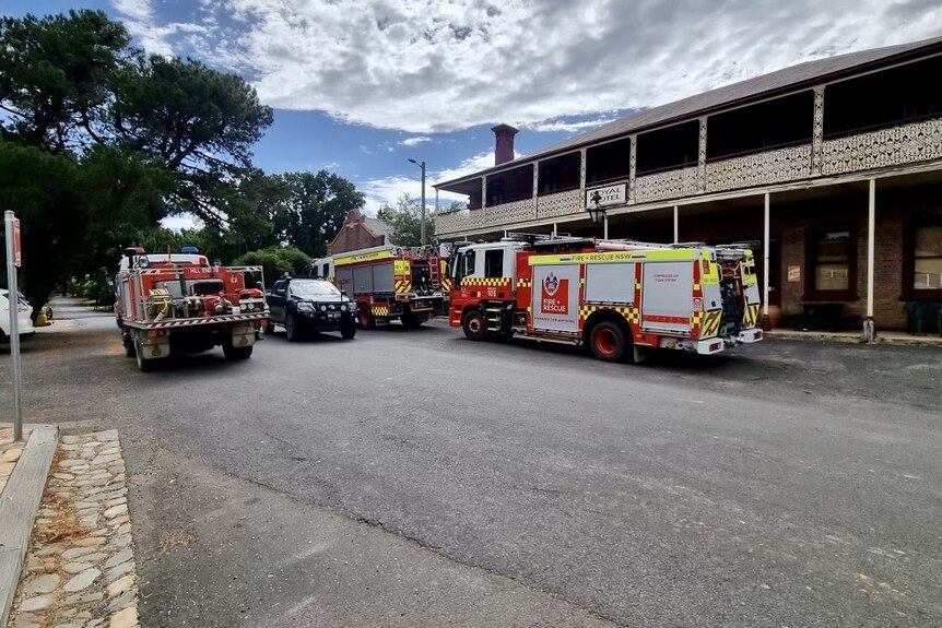 Fire trucks parked in a country town.