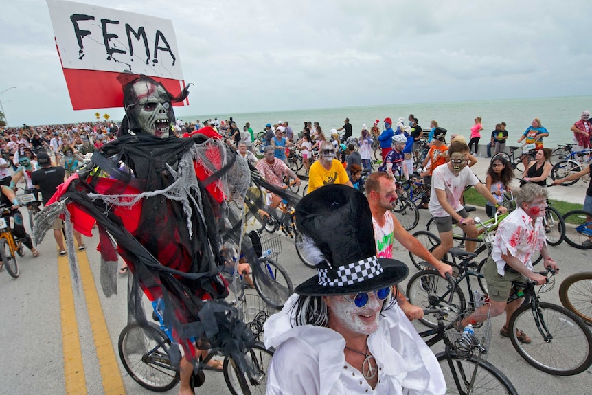 Participants dressed as zombies and in other horror-themed costumes ride bikes for the Zombie Bike Ride.