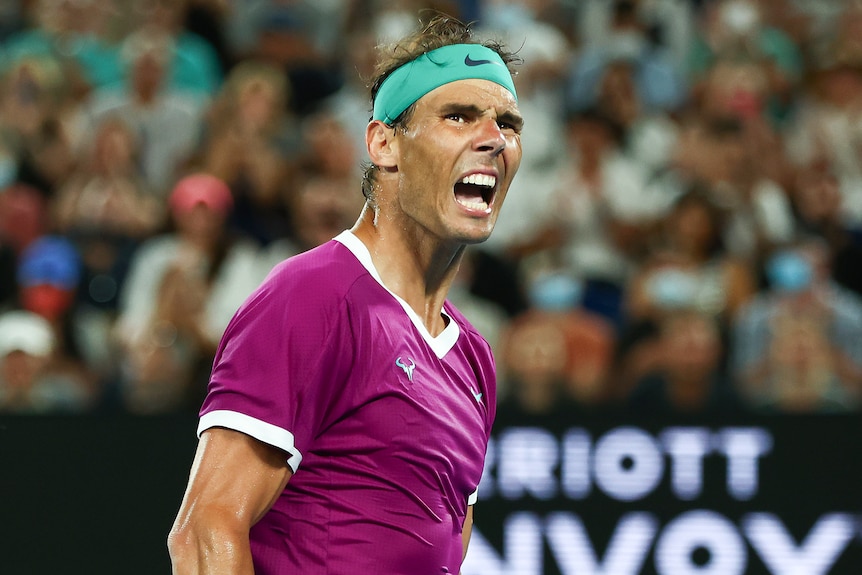 A Spanish male tennis player screams out as he celebrates winning a point.