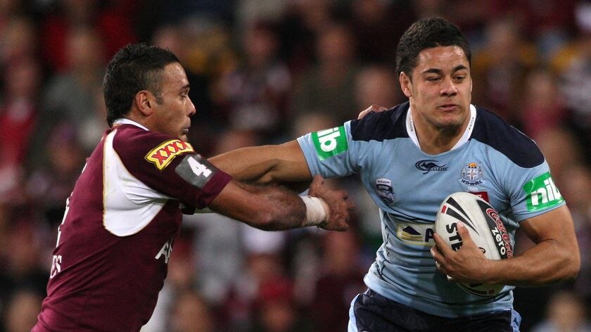 Jarryd Hayne of the Blues pushes away from Justin Hodges of the Maroons.